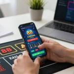 Engaging with mantra88's casino app, showcasing live dealer betting on smartphone in modern workspace